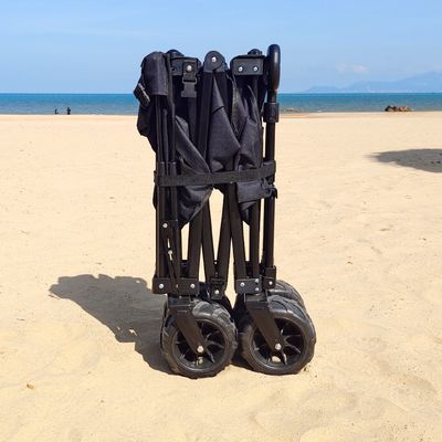 L'ampio vagone di piegatura della ruota accetta il carretto piegante a quattro vie su misura della spiaggia